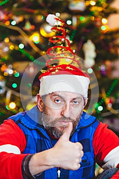 Man with beard in New Year cap with spiral