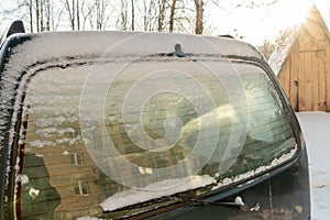 All the windows of the parked cars are covered with snow and ice. Frost on the windshield in the winter season. Big frosts and