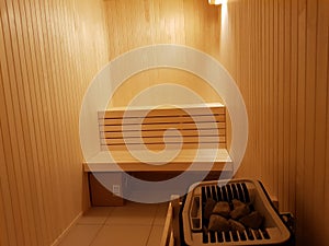 All wood sauna interior photo with calm lighting