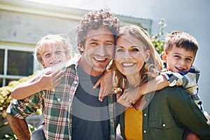 All you need is family to be truly happy. Portrait of a happy family spending time together outdoors.