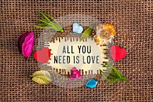 All you need is love written in hole on the burlap