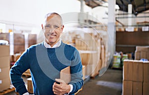 All your import and export needs. Portrait of a mature man standing in a distribution warehouse.