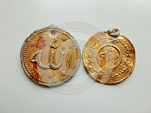 Allah is written on golden pendants