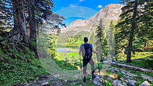 Allakogel - Hiker man with backpack with scenic view of alpine lake Sackwiesensee in Hochschwab mountain