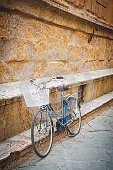 Alleging bike against a wall Tuscan monument