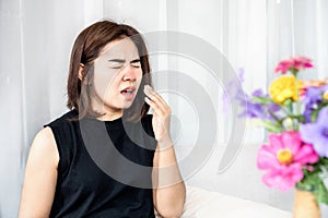 allergic Asian woman suffer from pollen allergy symptoms and sneezing photo