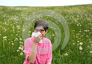 Allergic child blows his nose with white handkerchief