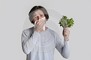 Allergic to product concept. Guy wipes his nose