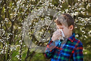 A boy with a handkerchief escapes from a spring Allergy .