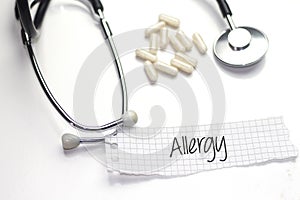 Allergy text on paper and stethoscope and white medicament