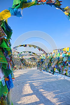 Alley of colorful prayer flags wind horse