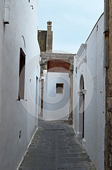 Alley in Greece, narrow, white and with charm. photo