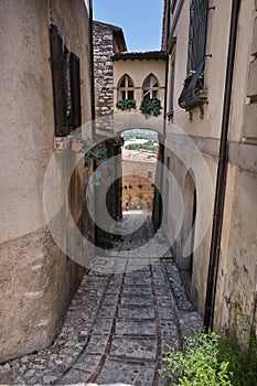 alley with inhabited bridge in the medieval town of spello umbria