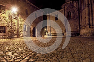 Alley from medieval times with paved ground and stone walls of the beautiful Cantabrian town Santillana del Mar. night photo