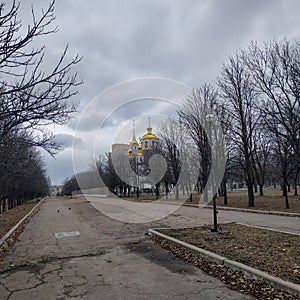 Alley in the park leading to the Holy Trinity Cathedral in Kramatorsk photo