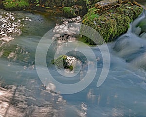 Alley Spring outflow rushing past moss covered rocks