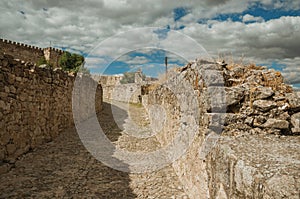 Alley with stone walls towards the Castle of Trujillo