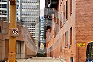 Alleyway in Chicago`s downtown Loop. Signs say No Parking and Truck Entrance.