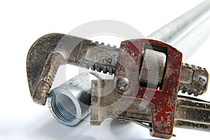 Alligator wrench with water pipes on white background