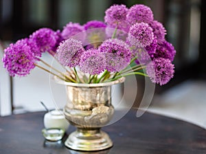 Allium flowers bouquet in a stylish decorative vase