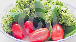 Allium ursinum wild bear garlic butter in a bowl with red tomatoes