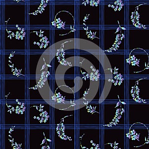 Allover flowers on black and blue plaid. seamless design.
