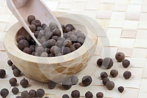 Allspice berries in a wooden pot