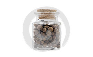 Allspice jamaican pepper in glass  jar on isolated on white background. front view. spices and food ingredients