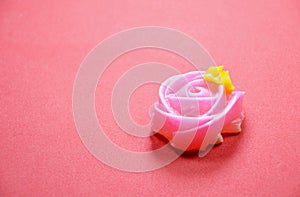 Allure colorful Thai candy with rose shape on red background