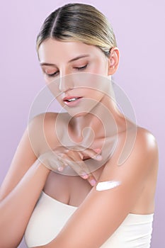 Alluring beautiful woman applying moisturizer cream on her arm concept.