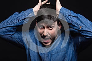Alluring man screaming posing in studio