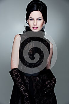 Alluring woman in black dress and gloves