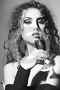 Alluring young woman with glass of wine