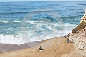 Almagreira Beach with surfer and fisherman waiting for Atlantic chances in Ferrel, Peniche, central western Coast of Portugal