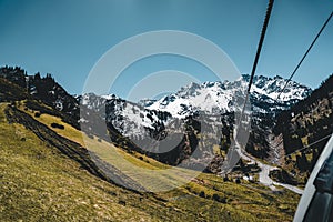 Almaty, Kazakhstan ski lift, cable car cabin at Medeo to Shymbulak route against mountain background