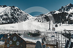 Almaty, Kazakhstan ski lift, cable car cabin at Medeo to Shymbulak route against mountain background