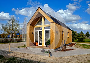 Outside view of a wooden tiny house on a beautiful day photo