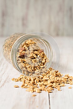 Almond Breakfast Granola Spilling From Glass Jar