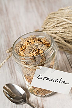 Almond Breakfast Granola With Tag On Glass Jar Close Up