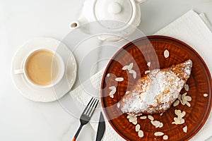 Almond Croissant on clay plate close up