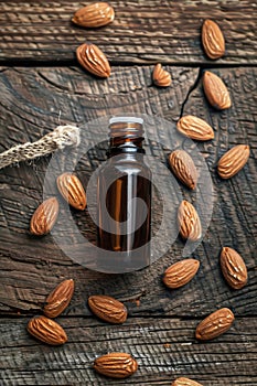 Almond essential oil in a bottle. Selective focus.