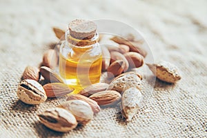 Almond essential oil in a small bottle. Selective focus
