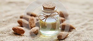 Almond essential oil in a small bottle. Selective focus