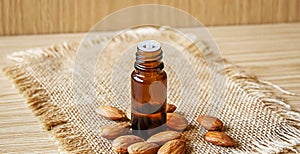 Almond essential oil in a small bottle. Selective focus