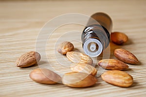 Almond essential oil in a small bottle. Selective focus