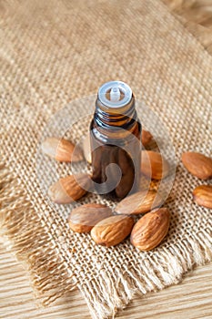 Almond essential oil in a small bottle. Selective focus