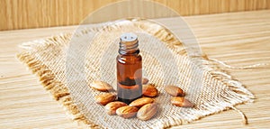 Almond essential oil in a small bottle. Selective focus