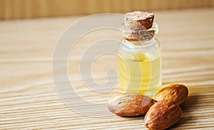 Almond essential oil in a small bottle. Selective focus