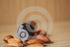 Almond essential oil in a small bottle. Selective focus