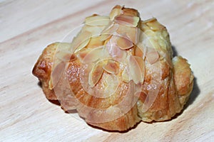 Almond flavor croissant placed on the wooden floor